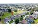 This aerial view shows a neighborhood with mature trees and well-maintained lawns at 925 Montana Ave, Davenport, FL 33897
