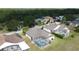 Aerial view of a home with a screened-in pool, surrounded by lush greenery at 925 Montana Ave, Davenport, FL 33897