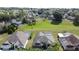 Beautiful homes featuring screened-in pools, lush landscaping, and a large community green space at 925 Montana Ave, Davenport, FL 33897