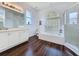Well-appointed bathroom with a tiled shower, a soaking tub, and updated vanity with double sinks at 925 Montana Ave, Davenport, FL 33897