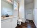 Bathroom with wood-look flooring, white cabinets, and updated countertops at 925 Montana Ave, Davenport, FL 33897