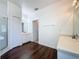 Primary bathroom featuring double sinks, a walk-in shower, and wood-look floors for a modern touch at 925 Montana Ave, Davenport, FL 33897
