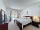 Comfortable primary bedroom featuring a king bed and sliding doors leading to a private pool area at 925 Montana Ave, Davenport, FL 33897