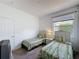 Bedroom featuring two twin beds, a window, closet, and a nightstand between the beds at 925 Montana Ave, Davenport, FL 33897
