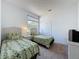 Bedroom with two twin beds featuring a window and closet at 925 Montana Ave, Davenport, FL 33897