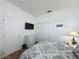 Bedroom with white walls featuring a mounted television and closet with double doors at 925 Montana Ave, Davenport, FL 33897