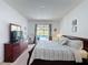 Spacious bedroom with a view of the backyard pool area, complete with a king size bed at 925 Montana Ave, Davenport, FL 33897