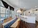 The dining area has a wooden table with a blue runner, chairs and nearby breakfast bar at 925 Montana Ave, Davenport, FL 33897