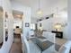 Bright dining area featuring a glass table, cushioned chairs, and modern chandelier lighting at 925 Montana Ave, Davenport, FL 33897