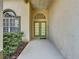 A welcoming front entryway with beautiful glass paneled doors at 925 Montana Ave, Davenport, FL 33897