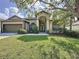 Charming home featuring a well-manicured lawn and a two-car garage at 925 Montana Ave, Davenport, FL 33897