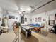 Spacious garage featuring an air hockey table, pool table, and a projector for ultimate entertainment at 925 Montana Ave, Davenport, FL 33897
