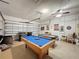Spacious garage has a pool table, air hockey table, and overhead door at 925 Montana Ave, Davenport, FL 33897