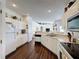 Well-lit kitchen featuring white cabinets, stainless sink and wood floors at 925 Montana Ave, Davenport, FL 33897