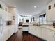 Well-lit kitchen featuring white cabinets, stainless sink, and wood floors at 925 Montana Ave, Davenport, FL 33897