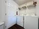 Functional laundry room includes washer, dryer, shelving, and convenient access to the rest of the home at 925 Montana Ave, Davenport, FL 33897