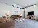 Cozy living room with neutral carpet and large screen TV at 925 Montana Ave, Davenport, FL 33897