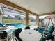A spacious lanai featuring a covered patio and screened-in pool and jacuzzi with lush green grass beyond at 925 Montana Ave, Davenport, FL 33897