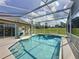 A screened-in pool and jacuzzi with tiled trim and ample space to lounge in the Florida sun at 925 Montana Ave, Davenport, FL 33897