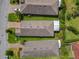 Aerial view of several residences showcasing rooflines, landscaping, and neighborhood street at 105 Palazzo Ln, Kissimmee, FL 34759