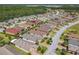 An aerial view of a community featuring many single-Gathering homes and lush trees and landscaping at 105 Palazzo Ln, Kissimmee, FL 34759