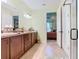 Bathroom featuring double vanity, walk-in shower, and access to bedroom at 105 Palazzo Ln, Kissimmee, FL 34759