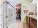 Bathroom features a large walk-in shower, double vanity, and access to the walk-in closet at 105 Palazzo Ln, Kissimmee, FL 34759