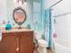 Well-lit bathroom featuring a vanity with granite countertop, a shower and framed mirror at 105 Palazzo Ln, Kissimmee, FL 34759