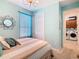 Comfortable bedroom with soft decor, closet, and a door leading to the laundry area at 105 Palazzo Ln, Kissimmee, FL 34759