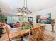 Elegant dining area showcasing an ornate chandelier and a decorative toucan themed wall art feature at 105 Palazzo Ln, Kissimmee, FL 34759