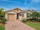 Charming single-Gathering home with a brick driveway, landscaped yard, and attached two-car garage at 105 Palazzo Ln, Kissimmee, FL 34759