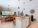 Bright kitchen featuring granite countertops, a stainless steel sink, and an open view of the dining and living spaces at 105 Palazzo Ln, Kissimmee, FL 34759