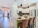 Bright eat-in kitchen features an island with bar stool seating, pendant lighting, and stainless steel appliances at 105 Palazzo Ln, Kissimmee, FL 34759