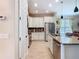 Modern kitchen with white cabinets, stainless steel appliances, granite countertops, and tile backsplash at 105 Palazzo Ln, Kissimmee, FL 34759