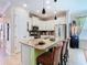 Updated kitchen includes an island with bar stool seating, stainless steel appliances, and modern lighting at 105 Palazzo Ln, Kissimmee, FL 34759