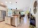 Open-concept kitchen with a granite island, stainless steel appliances, and a seamless flow to the living areas at 105 Palazzo Ln, Kissimmee, FL 34759
