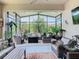 Spacious screened-in patio with comfortable wicker furniture and lush landscaping at 105 Palazzo Ln, Kissimmee, FL 34759