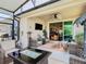 Inviting screened patio with wicker furniture and ceiling fan, ideal for outdoor entertaining at 105 Palazzo Ln, Kissimmee, FL 34759