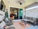 Relaxing screened patio featuring comfortable wicker furniture and sliding glass doors to the living area at 105 Palazzo Ln, Kissimmee, FL 34759