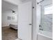 Bathroom with marble tile and a view to a bedroom with ceiling fan at 1058 Splash Shot Pl, Davenport, FL 33896