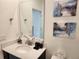 Modern bathroom with stylish vanity, decor, and decorative art at 1058 Splash Shot Pl, Davenport, FL 33896