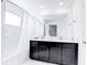Bright bathroom with double sinks, dark cabinets, and a tub with a shower at 1058 Splash Shot Pl, Davenport, FL 33896
