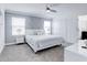 Bright bedroom featuring a queen bed, ceiling fan, and a modern accent wall at 1058 Splash Shot Pl, Davenport, FL 33896