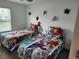Bedroom featuring twin beds with superhero bedding and themed wall decorations at 1058 Splash Shot Pl, Davenport, FL 33896