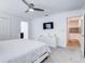 Bright bedroom with a ceiling fan, TV, and ensuite bathroom access at 1058 Splash Shot Pl, Davenport, FL 33896