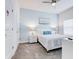 Serene bedroom featuring soft blue walls, plush carpet, and a cozy bed at 1058 Splash Shot Pl, Davenport, FL 33896