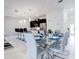 Dining area leading to the kitchen featuring a glass table set for a formal meal at 1058 Splash Shot Pl, Davenport, FL 33896