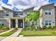 Modern townhouse featuring a landscaped front yard and a contemporary architectural design at 1058 Splash Shot Pl, Davenport, FL 33896