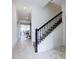Bright hallway with tile flooring, a staircase, and access to dining area at 1058 Splash Shot Pl, Davenport, FL 33896