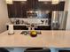 This kitchen offers quartz countertops, stainless appliances, and dark cabinets at 1058 Splash Shot Pl, Davenport, FL 33896